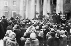 Revolución rusa. Derrocamiento del zar Nicolás II en marzo de 1817. Una multitud se reune en las afueras de la Duma imperial en medio de un severo desgaste economico en la vida civil provocado por la participación de Rusia en la Primera Guerra Mundial. A la derecha se observa un letrero con la frase 